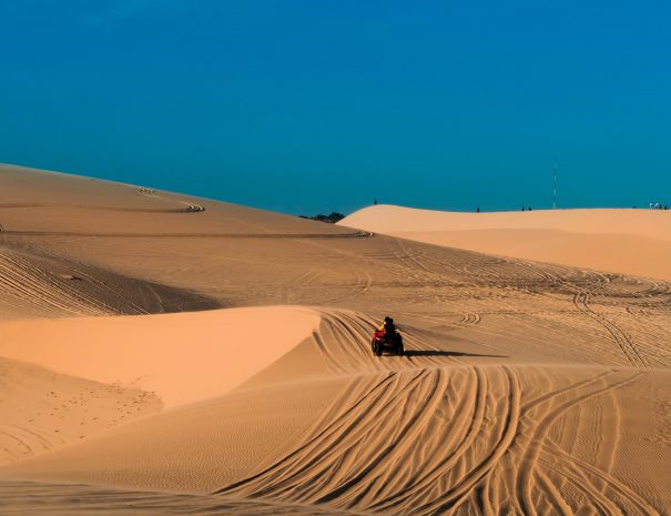 Beautiful landscape, desert with blue sky of white sand Dunes (Doi Cat Trang), the popular tourist attraction place in Mui Ne, Vietnam; Shutterstock ID 1329611159; purchase_order: -; job: -; client: -; other: -