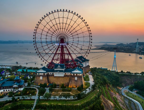 HA LONG, VIETNAM - SEP 28, 2018: Top view aerial photo from flying drone of a Ha Long City with development ferris wheel, aerial cable or telepheric. Near Ha Long bay; Shutterstock ID 1218773887; purchase_order: -; job: -; client: -; other: -